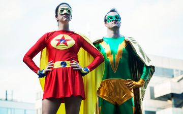 A woman and a man dressed as superheroes