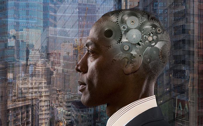 An African-American man stares out a window with cogs superimposed over his brain